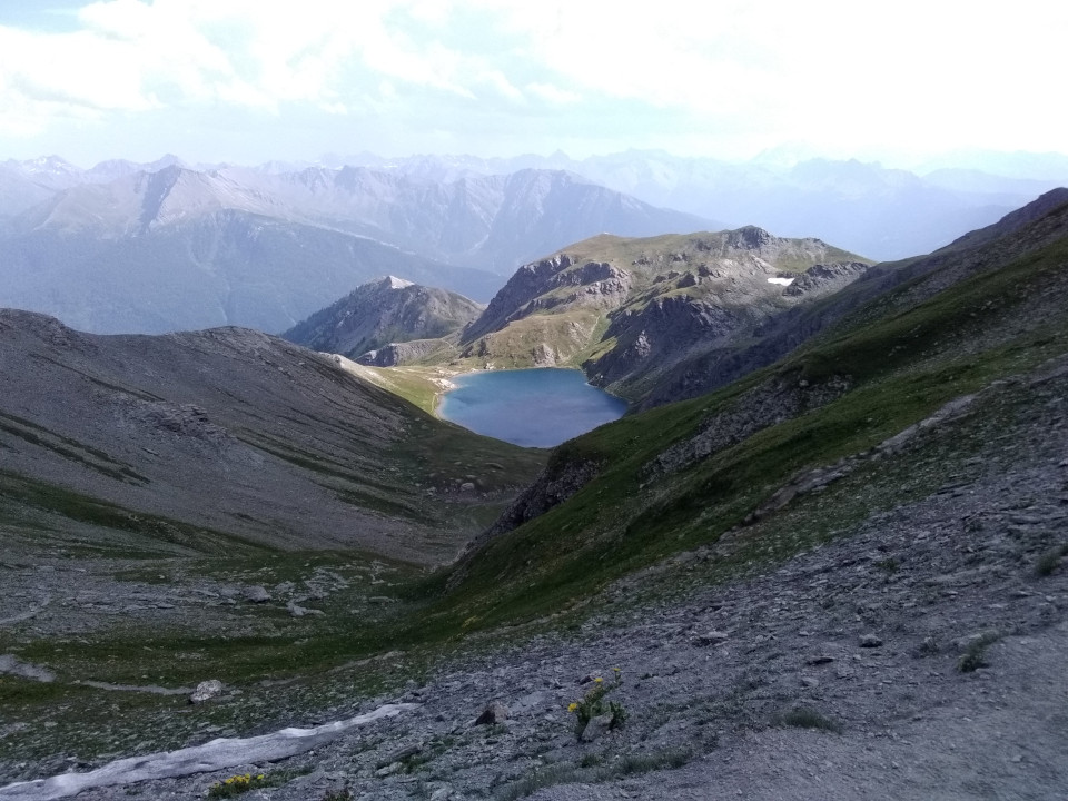Photo prise depuis le col du Malrif, situé sur la route du GR58 nommé 'Le Tour du Queyras' (dans les Alpes). La photo est prise en plongée, il y a le lac du grand Laus en contrebas.